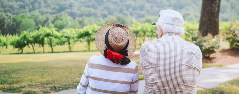 senior couple sitting on mountainside