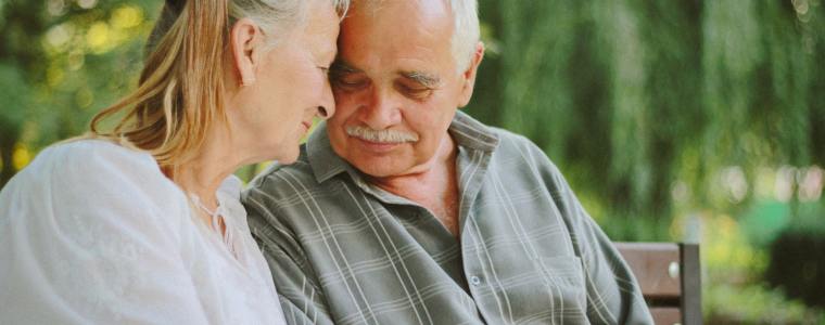 elderly woman with husband on bench