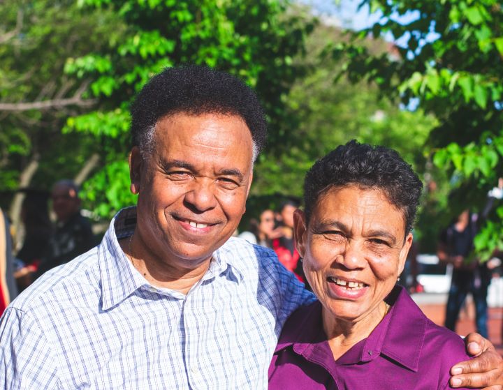 elderly couple smiling outside