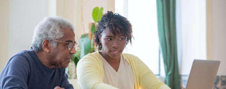 elderly man looking up nursing homes on a laptop
