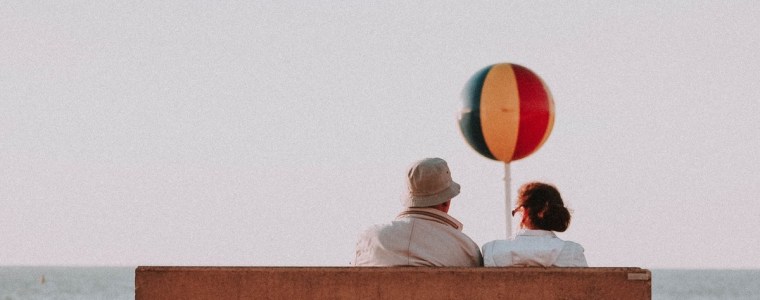 elderly couple sitting seaside