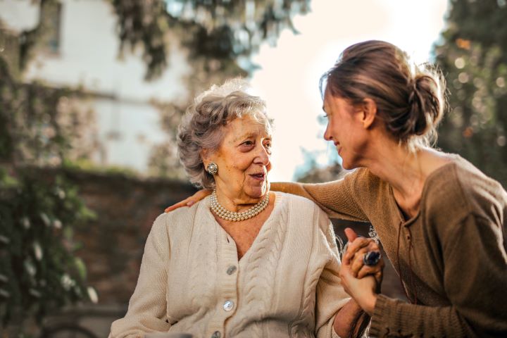 woman with arm around elderly woman